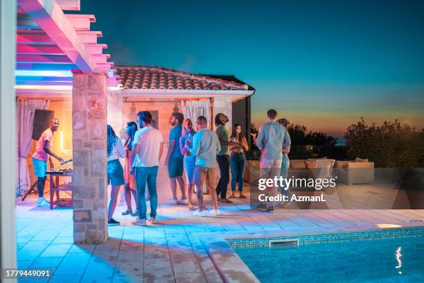 diverse friends enjoying pool party - pool party night stock pictures, royalty-free photos & images