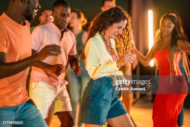 joyful friends celebrating by the pool at night - pool party night stock pictures, royalty-free photos & images