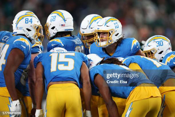Justin Herbert of the Los Angeles Chargers huddles with teammates during the second half against the New York Jets at MetLife Stadium on November 06,...