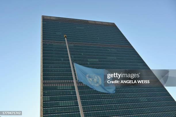 Flag is flown at half mast at the United Nations headquarters in New York on November 13, 2023 as staff observe a minute's silence in memory of...