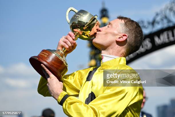 Mark Zahra poses with trophy after riding Without A Fight to win Race 7, the Lexus Melbourne Cup, during Melbourne Cup Day at Flemington Racecourse...