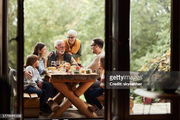 family's lunch on a patio! - generational family stock pictures, royalty-free photos & images