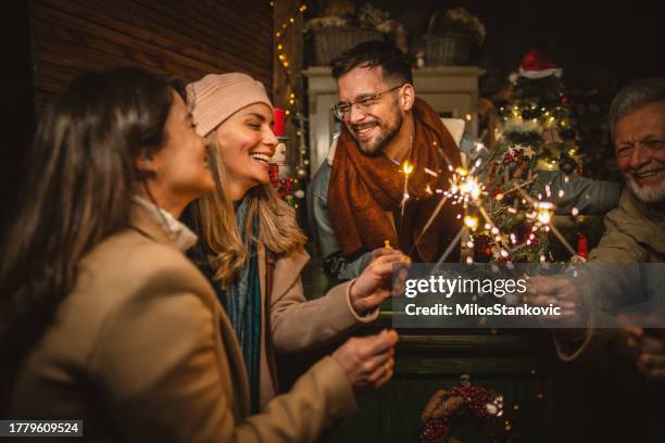 happy family celebrating christmas holidays outdoor - family fireworks stockfoto's en -beelden