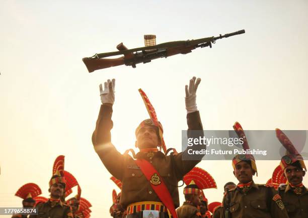 November 09 Srinagar Kashmir, India : A New recruit of the Indian Border Security Force tosses his rifle to celebrate after the passing out parade in...