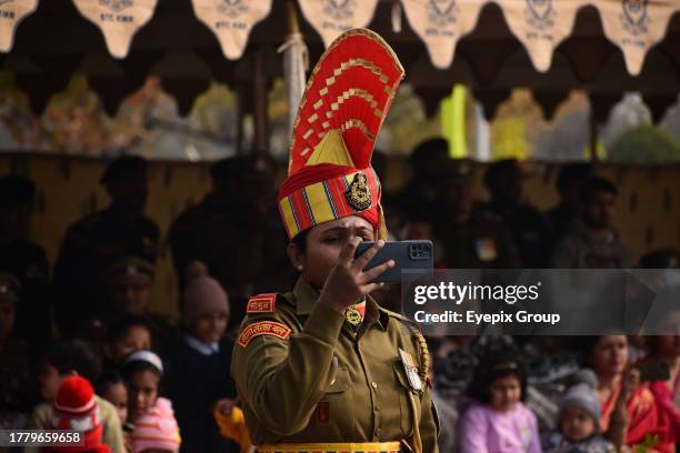 November 09 Srinagar Kashmir, India : A woman soldier of Indian Border Security Force takes a picture during a passing out parade in Humhama, on the...