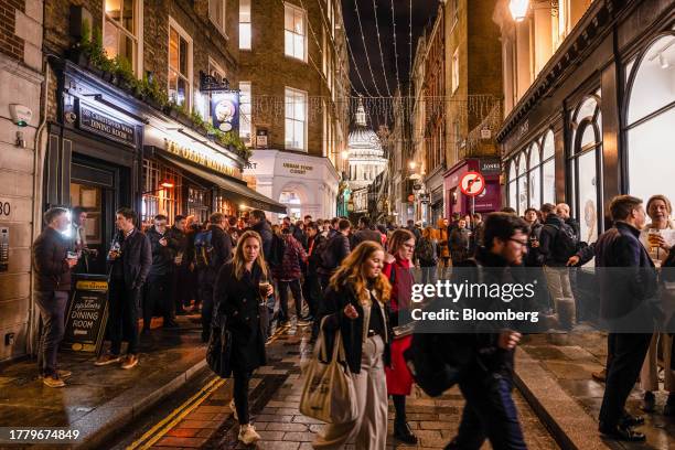 Customers outside the Ye Olde Watling pub near St. Paul's Cathedral in the City of London, UK, Thursday, Nov. 9, 2023. City center pubs, still in...