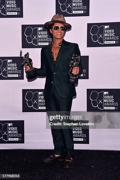 Bruno Mars poses with his two awards at the 2013 MTV Video Music Awards at the Barclays Center on August 25, 2013 in the Brooklyn borough of New York...