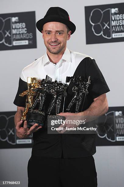 Justin Timberlake poses with the Michael Jackson Video Vanguard Award and the awards for Best Direction, Best Editing, and Video of the Year the 2013...