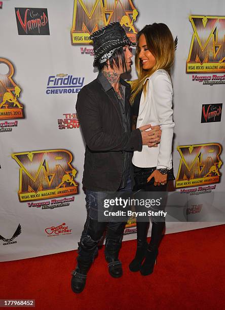 Guitarist Dj Ashba and model Nathalia Henao arrives at the Vegas Rocks! Magazine Music Awards 2013 at the Joint inside the Hard Rock Hotel & Casino...