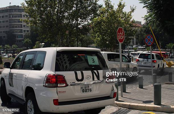 Convoy of United Nations vehicles leave a hotel in Damascus on August 26, 2013 carrying UN inspectors travelling to the site of a suspected deadly...