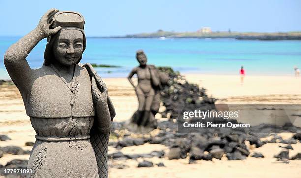 sea women statues on the beach at udo - jeju island stock pictures, royalty-free photos & images