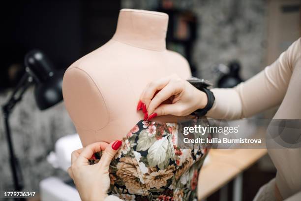 hands of unrecognizable female tailor with magnetic bracelet for pins breathe life into feminine corset - needlecraft product stock pictures, royalty-free photos & images