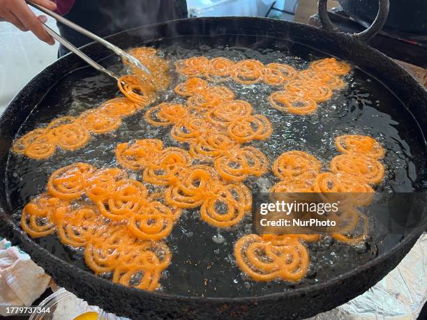 Man preparing jalebis during the festival of Diwali at a sweetshop in Mississauga, Ontario, Canada, on November 12, 2023.