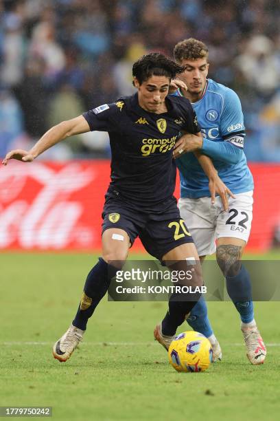 Empoli's Italian forward Matteo Cancellieri challenges for the ball with SSC Napoli's Italian defender Giovanni Di Lorenzo during the Serie A...