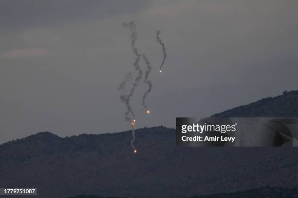 Flares descend over Israel's northern border with Lebanon on November 13, 2023 in Northern Israel, Israel. A month after Hamas's Oct. 7 attacks that...