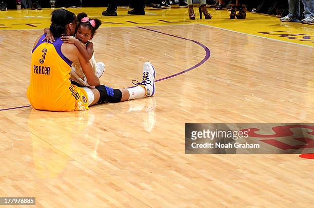 Candace Parker of the Los Angeles Sparks hugs her daughter Lailla Williams on the court after the game against the Tulsa Shock at Staples Center on...