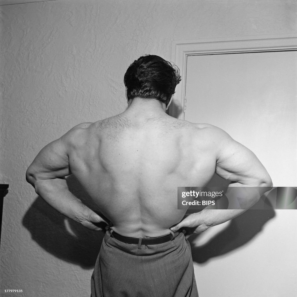 English bodybuilder Reg Park flexes his muscles, circa 1955. Park was