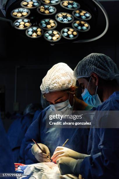 vertical photo of a concentrated surgeon on duty - medical technical equipment stock pictures, royalty-free photos & images