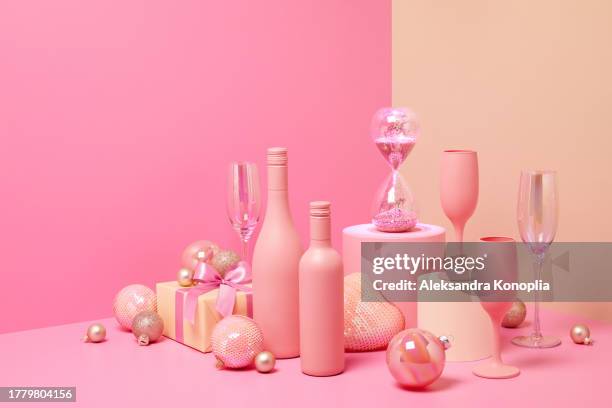 abstract pastel colored 3d scene with pink and beige background, wine bottles,  champagne glasses, sparkling hourglass, christmas gifts and ornaments. - champange bottle and valentines day stock pictures, royalty-free photos & images