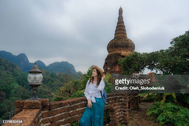 woman looking at jungles from temple in thailand - krabi stock pictures, royalty-free photos & images
