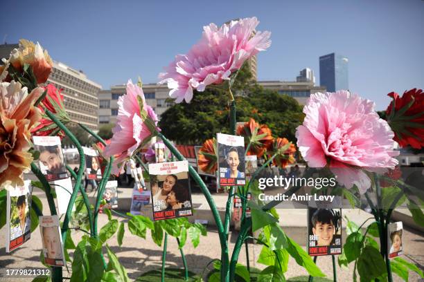 Posters with faces of hostages taken in the October 7 attacks are seen ahead of a moment of silence commemorating the attacks' victims on November 7,...