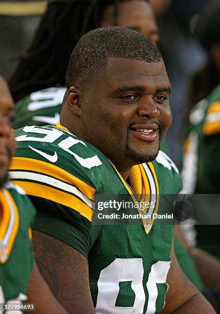 Raji of the Green Bay Packers watches from the bench as his teammates take on the Arizona Cardinals at Lambeau Field on August 9, 2013 in Green Bay,...