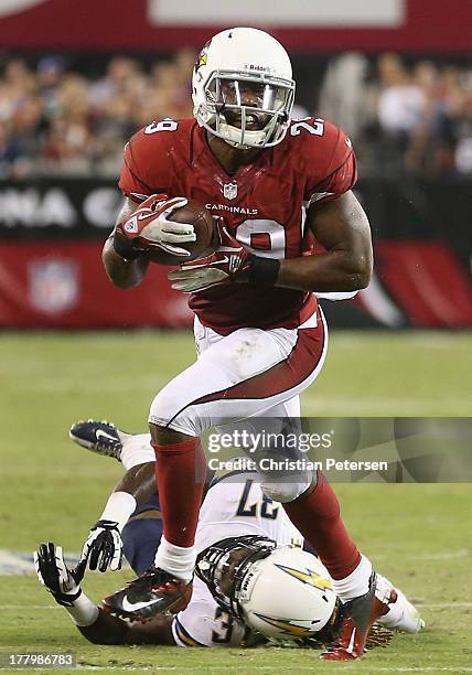 Running back Alfonso Smith of the Arizona Cardinals runs with the football after a reception past defensive back Jahleel Addae of the San Diego...