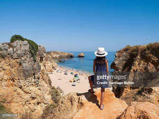 girl looking at the sea from clift - albufeira stock pictures, royalty-free photos & images