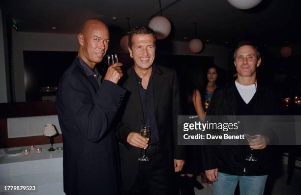 British fashion journalist Michael Roberts , Peruvian photographer Mario Testino , and American entrepreneur Ian Schrager attend a launch party for...