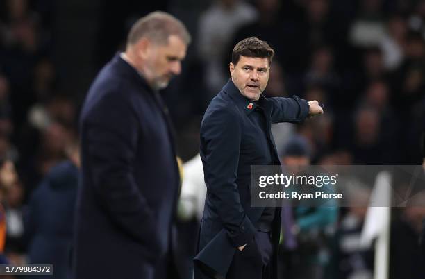 Mauricio Pochettino, Manager of Chelsea reacts as Ange Postecoglou, Manager of Tottenham Hotspur, looks on in the foreground during the Premier...