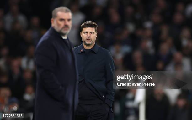 Mauricio Pochettino, Manager of Chelsea reacts as Ange Postecoglou, Manager of Tottenham Hotspur, looks on in the foreground during the Premier...