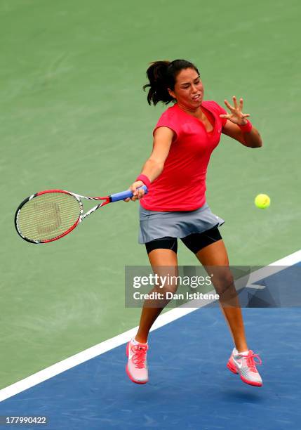 Jamie Hampton of United States of America plays a forehand against Lara Arruabarrena of Spain during their first round match on Day One of the 2013...