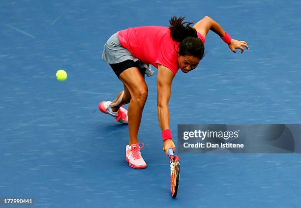 Jamie Hampton of United States of America plays a backhand against Lara Arruabarrena of Spain during their first round match on Day One of the 2013...