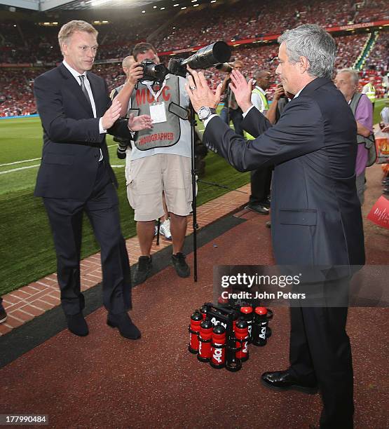 Manager David Moyes of Manchester United greets manager Jose Mourinho of Chelsea ahead of the Barclays Premier League match between Manchester United...