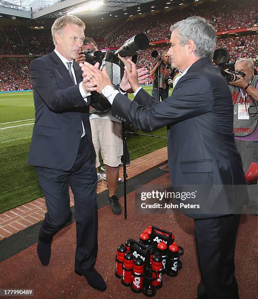 Manager David Moyes of Manchester United greets manager Jose Mourinho of Chelsea ahead of the Barclays Premier League match between Manchester United...