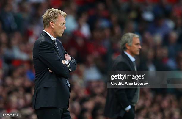 Manchester United Manager David Moyes and Chelsea Manager Jose Mourinho ( look on during the Barclays Premier League match between Manchester United...