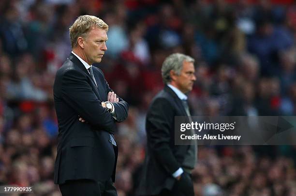 Manchester United Manager David Moyes and Chelsea Manager Jose Mourinho ( look on during the Barclays Premier League match between Manchester United...