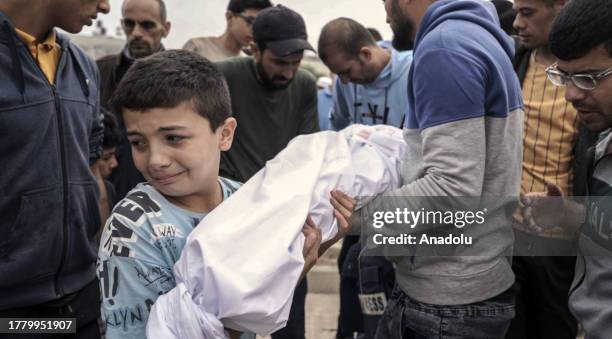 Relatives of Anadolu Agency's freelance cameraman Yasser Qudih mourn after losing 8 of his relatives during Israeli attacks in Khan Yunis, Gaza on...