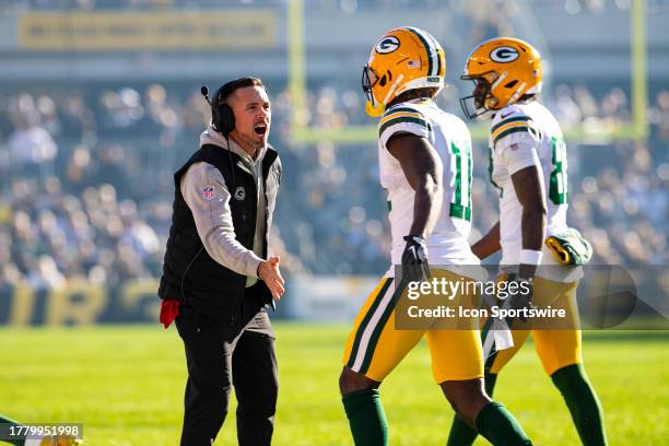 Green Bay Packers head coach Matt LaFleur greets Green Bay Packers wide receiver Jayden Reed after a touchdown during the regular season NFL football...