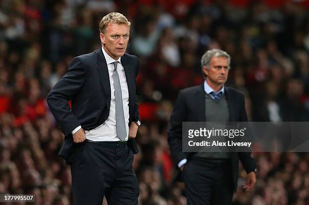 Manchester United Manager David Moyes and Chelsea Manager Jose Mourinho look on during the Barclays Premier League match between Manchester United...