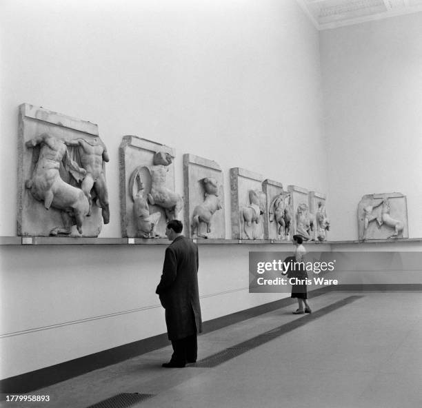 Visitors viewing the Parthenon Sculptures, also known as the Elgin Marbles, in the Egyptian Galleries at the British Museum, London, May 1954.