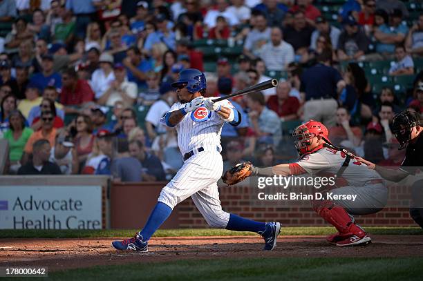 Darnell McDonald of the Chicago Cubs bats as Rob Johnson of the St. Louis Cardinals catches at Wrigley Field on August 16, 2013 in Chicago, Illinois....