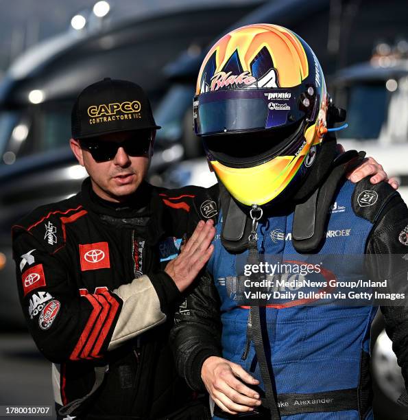 Pomona, CA Top Fuel driver Steve Torrence, left, consoles Funny Car driver Blake Alexander, right, following his semi final round loss to Chad Green...