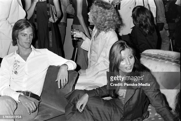Keith Carradine, Genevieve Waite, and Apollonia van Ravenstein attend a party at On the Rox, a nightclub in West Hollywood, California, on July 28,...