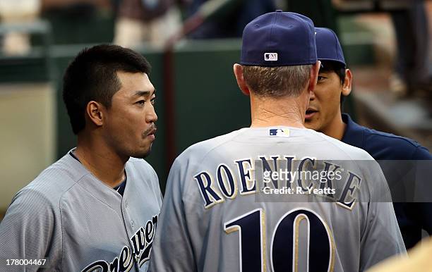 Norichika Aoki talks with Ron Roenicke of the Milwaukee Brewers prior to the interleague game against the Texas Rangers at Rangers Ballpark in...