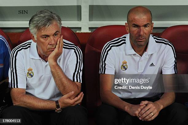 Real Madrid head coach Carlo Ancelotti looks on with his assistent Zinedine Zidane during the La Liga match between Granada CF and Real Madrid CF at...