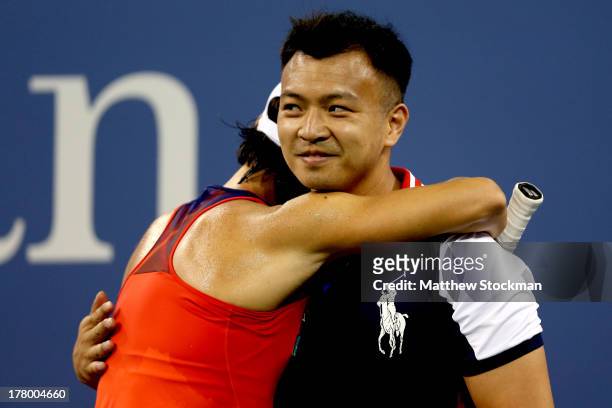 Francesca Schiavone of Italy hugs a ball boy during her first round women's singles match against Serena Williams of the United States of America on...