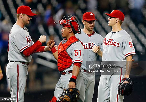 Kyle Kendrick catcher Carlos Ruiz, Cliff Lee and Jonathan Papelbon of the Philadelphia Phillies congratulate each after defeating the New York Mets...