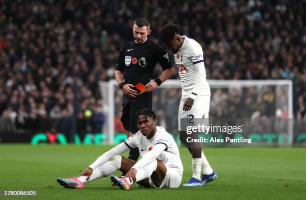 Destiny Udogie of Tottenham Hotspur is shown a red card by referee Michael Oliver during the Premier League match between Tottenham Hotspur and...
