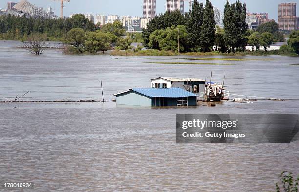 Houses are submerged by flood water on August 26, 2013 in Harbin, China. 85 people were killed and 105 others missing as rainstorms have caused havoc...